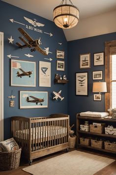 a baby's room with blue walls and pictures on the wall, including an airplane