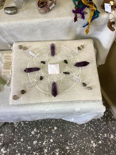 a white table topped with lots of glass beads and other things on top of it