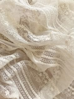 an image of white fabric with lace on it