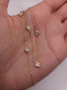 "This is a beautiful diamond by the yard necklace with Lab Grown Diamonds. It has 5 diamonds set in real solid 14Kt Gold. You can choose if you want 14Kt White Gold, 14Kt Yellow Gold or 14Kt Rose Gold.  We have a lot of beautiful jewelry with natural diamonds.  If any listing states \"diamond\" then it is a natural diamond. If the listing states \"Lab Grown\" it is a Lab Grown diamond. This is the perfect gift for mom, wife, fiancee, girlfriend, valentine, daughter, family or friend. It is a special gift for mother's day, valentine's day, wedding, anniversary, birthday, Christmas, Easter, New Year's and any holiday. Total Diamonds: 5 Each diamond is 0.25 Ct 1.25 Ct Total Diamond Weight Clarity: VS-SI Color: FG Color 3.56 Grams  4.75 mm Bezel Size 0.030 inch Chain Width 18 inch chain (if yo Diamonds By The Yard, Adjustable Gold Diamond Necklace Gift, Diamond By Yard Necklace, Diamonds By The Yard Necklace, Gold Diamond Necklace With Single Lab-grown Diamond, Refined Gold Brilliant Cut Diamond Necklace, Diamond By The Yard Necklace, Dainty 14k Gold Diamond Necklace, Tarnish Resistant, Tennis Jewelry