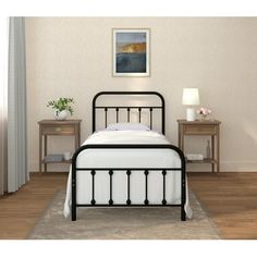 a black metal bed frame in a bedroom