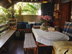 a table and benches in a room with wooden walls