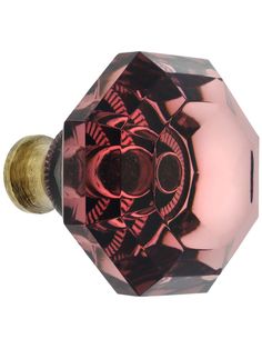 a pink glass door knob with an intricate design on it