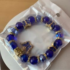 Brand New In Sealed Package Blue Beaded Bracelet With Butterfly Charm Blue Adjustable Charm Bracelet For Party, Adjustable Blue Charm Bracelet For Party, Adjustable Blue Charm Bracelet For Parties, Blue Bracelets With Round Beads For Fashion, Blue Charm Bracelet For Party, Blue Beaded Stretch Bracelet For Party, Casual Blue Beaded Stretch Bracelet, Blue Faceted Beads Casual Style, Blue Beads For Jewelry Making