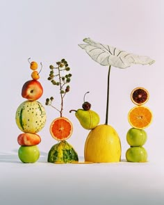 an arrangement of fruits and vegetables arranged in the shape of a pyramid on a white background