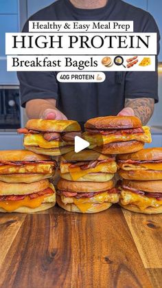 a man is stacking up breakfast bagels on top of a wooden table with the words, healthy & easy meal prep high protein breakfast bagsels