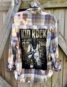 This is a one of a kind KID ROCK plaid flannel shirt.  This size Xlarge flannel shirt has two pockets on the front, buttons up and is long sleeve. On the back of the flannel there's a original Kid Rock tee that has been sewn into it. The flannel has been frayed trimming around the tee. This shirt has been bleached which gives it an overall distressed vintage style look.  All my shirts are ONE OF A KIND. They are all upcycled by being previously owned so there will be signs of wear and tear. This Flannel Shirt Refashion, Distressed Long Sleeve, Upcycle Clothes Diy, Shirt Refashion, Rock Tees, Kid Rock, Clothes Diy, Oversized Jacket, Plaid Flannel Shirt