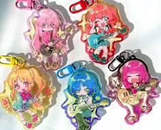 four keychains with cartoon characters on them, one is holding a guitar and the other has an electric guitar