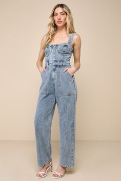 This spring will be full of admirers and compliments with a trendy look like the Lulus Fresh Perfection Light Wash Bustier Sleeveless Denim Jumpsuit! Slightly acid-washed 100% cotton denim shapes this too-cool jumpsuit that features a bustier-inspired bodice with seamed cups and a sweetheart neckline, supported by wide adjustable tank straps. A hidden snap button placket secures the front of the bodice, atop a banded waist with convenient belt loops and a hidden zip fly. The relaxed, straight pa Summer Light Wash Denim Jumpsuit With Bib Front, Light Wash Denim Jumpsuit With Bib Front For Summer, Light Wash Bib Front Denim Jumpsuit For Summer, Denim Blue Bib Front Jumpsuit For Spring, Denim Blue Bib Front Jumpsuits And Rompers For Spring, Spring Bib Front Denim Jumpsuit, Chic Light Wash Denim Jumpsuit For Spring, Chic Sleeveless Denim Jumpsuit With Pockets, Chic Sleeveless Cotton Denim Jumpsuit