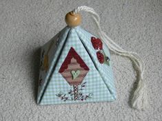 an ornament shaped like a house on the floor