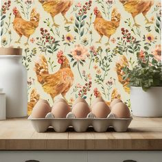 an egg carton with six eggs in it on a counter next to a wallpaper