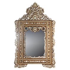 an ornately decorated mirror with gold trimming