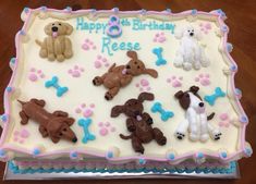 a birthday cake with dogs and bones on it