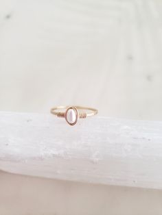 This dainty and feminine freshwater pearl ring is classic, minimal and beautiful! Pairs well with other rings or on its own. Genuine freshwater pearl is lovingly wrapped onto a hand formed and hammered band. The hammering gives lovely shimmery texture and also adds strength to the band! Made from top quality materials - true 14k gold fill or solid sterling silver - will not turn your finger green or wear off. Wear 24/7! Lead and nickel free. Excellent for sensitive skin. Comes packaged in a box Handmade Dainty Pearl Open Ring, Dainty Tiny Pearl Ring For Everyday, Dainty Handmade Pearl Open Ring, Delicate Stackable Pearl Ring For Promise, Delicate Stackable Pearl Promise Ring, Delicate Stackable Pearl Ring As Promise Ring, Minimalist Adjustable Rings With Pearl Drop, Minimalist Adjustable Ring With Pearl Drop, Dainty Rose Gold Pearl Ring For Promise