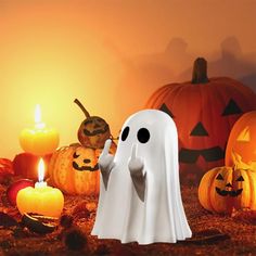 a group of halloween pumpkins with ghost figures in the foreground and candles on the ground