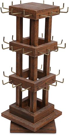 a wooden structure with multiple compartments and hooks on each side, in the shape of a tower