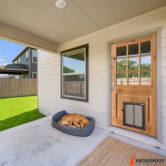 a dog laying in his bed on the front porch