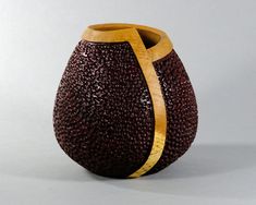 a brown vase with a gold strip on it