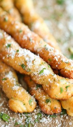 some fried food is covered with powdered sugar and garnished with parsley