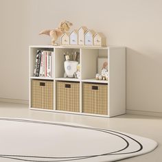 a white shelf with baskets and toys on it