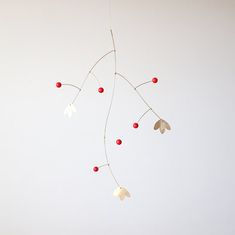 a mobile with leaves and berries hanging from it