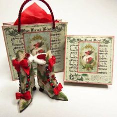 a pair of christmas boots sitting on top of a table next to a small bag