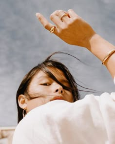 a woman holding her hand up in the air