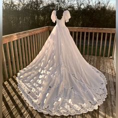 a white wedding dress on a wooden deck