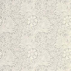 an old wallpaper pattern with white flowers and leaves on the side, in shades of gray