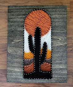 a piece of art that has been made to look like an orange and black cactus