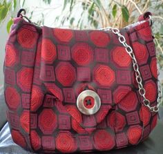 a red and black purse sitting on top of a table