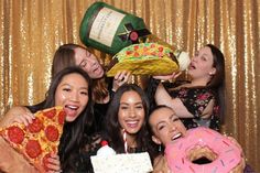 a group of people posing for a photo with food and drinks