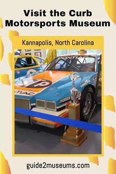 a car is on display in a museum with the words, visit the curb motorsports museum kannapolis, north carolina