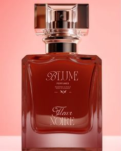 a bottle of perfume on a pink background