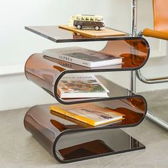 a glass shelf with books and a toy car on top