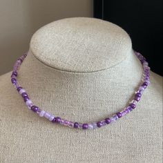 This choker is a mixture of multiple clear and purple seed beads. This choker can be worn as both a choker and a necklace. It is adjustable from 14-16 inches. This necklace is lead and nickel free making it hypoallergenic. It is great to be worn alone or to be stacked with other necklaces. It is made with 6/0 seed beads meaning they are 3-4 mm. It is very trendy and beautiful. Beaded Jewelry Purple, Purple Beaded Chain Necklace With Round Beads, Purple Beaded Chain Necklace, Purple Seed Bead Necklace, Lavender Jewelry With Tiny Beads For Gifts, Purple Choker For Festivals, Handmade Adjustable Lavender Beaded Necklaces, Handmade Lavender Beaded Necklaces, Adjustable Lavender Single Strand Necklace