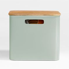 a green storage box with a wooden lid