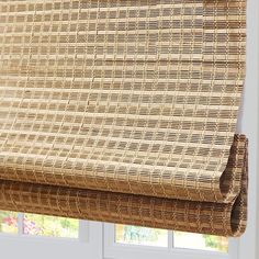 a close up of a window with blinds made out of wicker and bamboo material