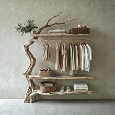 a wooden shelf with clothes hanging on it