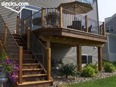 an image of a deck with stairs and railings in the front yard or back yard