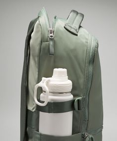 a backpack with a water bottle attached to it