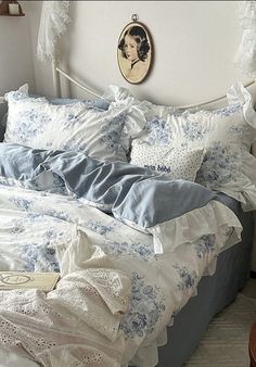 a bed with blue and white comforters in a bedroom