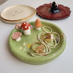 two plates with rings on them sitting on a table next to other dishes and decorations