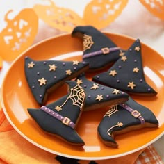 decorated cookies in the shape of witches on a plate