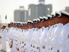 rows of men in white uniforms lined up