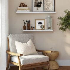 a living room with two shelves and a chair