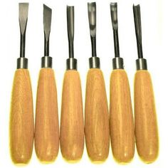 six wood carving tools lined up in a row