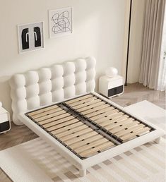 a white bed frame with wooden slats