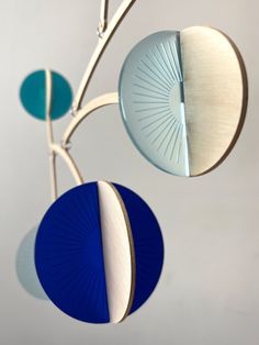 three circular objects hanging from a metal rod