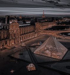 an aerial view of the pyramids and buildings in paris, france at night time